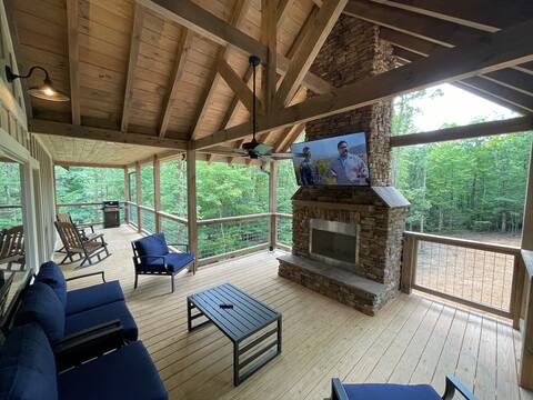 SwimTastic covered patio with stone fireplace